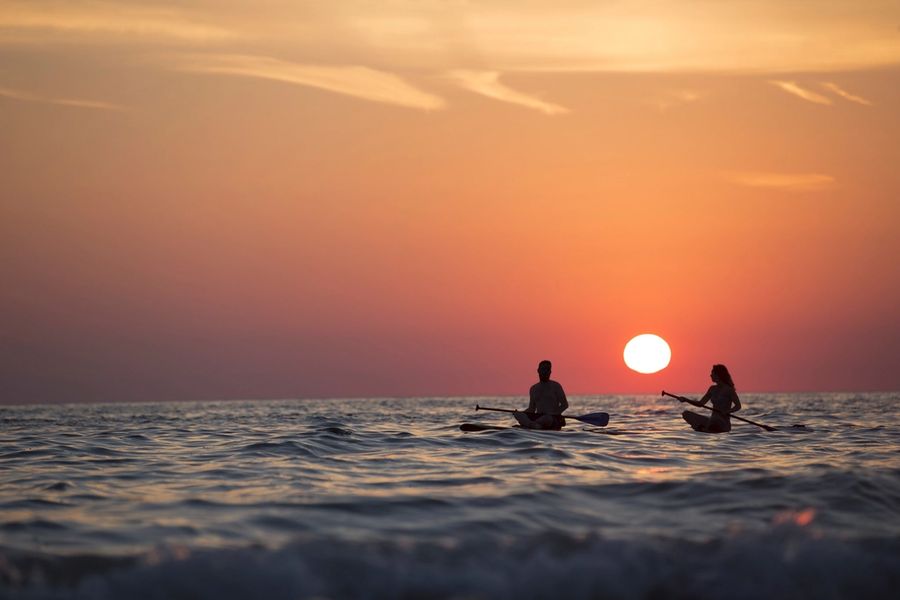 Two kayakers at sunset