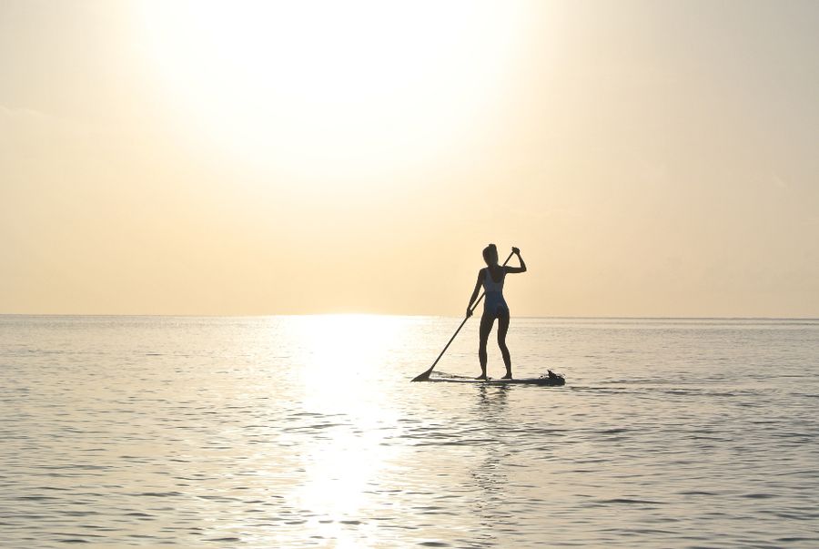 Stand-up paddleboarder at golden hour